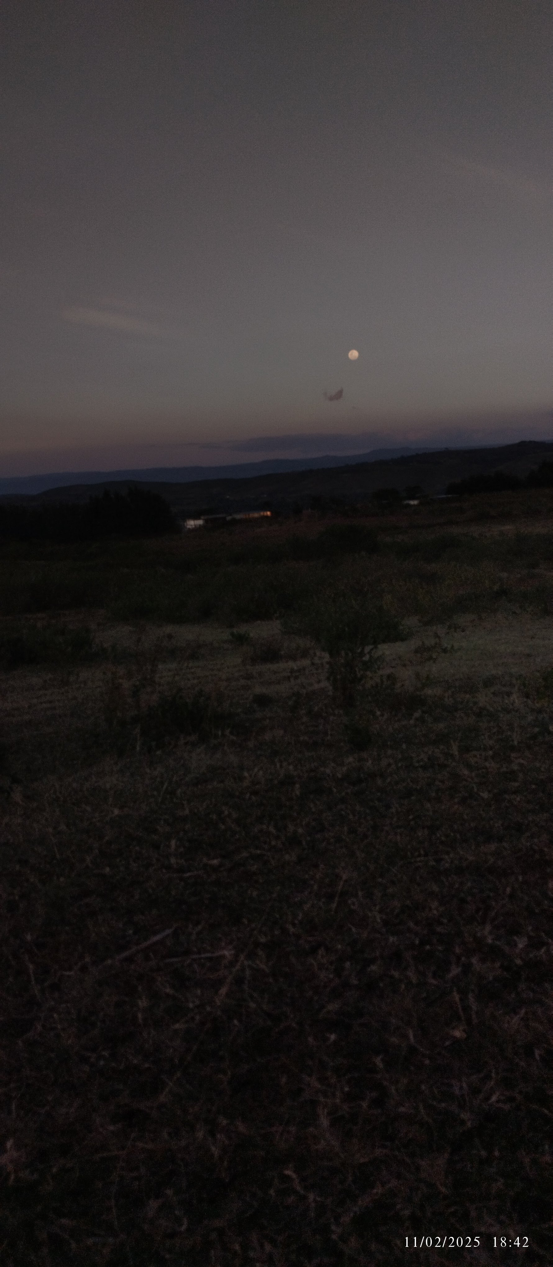 The full moon rising over the plains, photographed from the same escarpment, 2025